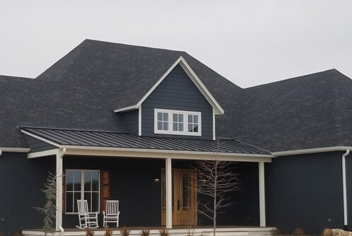 Roof Replacement on a Dark Blue House